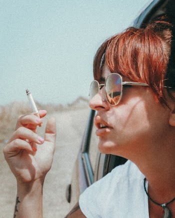 Photo of Woman Wearing Sunglasses While Smoking