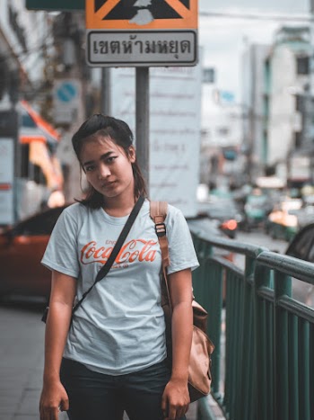 Photo of Woman Wearing White Shirt Near Metal Railings