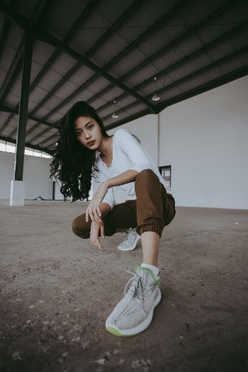 Photo Of Woman Wearing White Sneakers