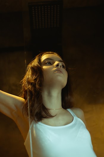 Photo of Woman Wearing White Top Tank