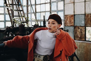 Photo of Woman Wearing White Turtleneck  Shirt and Orange Coat