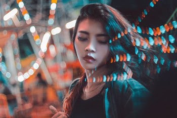 photo of woman with bokeh lights background