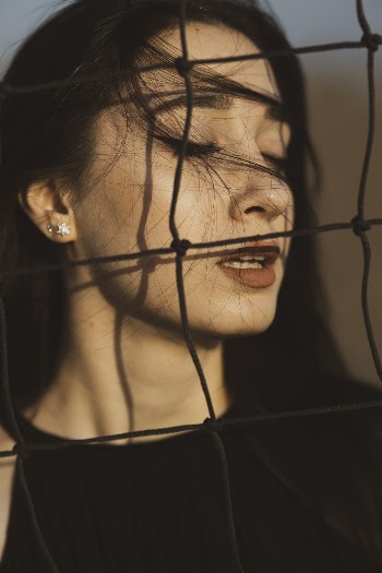 Photo of Woman with Closed Eyes near Net