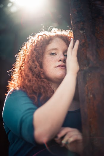 Photo of Woman With Freckles Posing by Tree