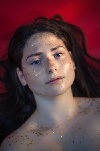 Photo of Woman With Glitters on Her Face and Skin
