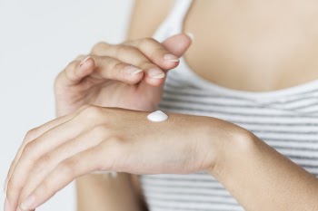 Photo of Woman With Lotion on Hand