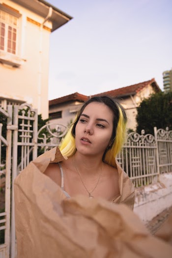 Photo of Woman with Yellow Highlights Wrapped in Brown Paper