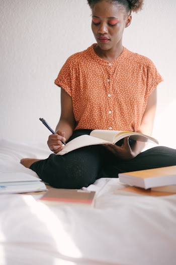 Photo Of Woman Writing On Book