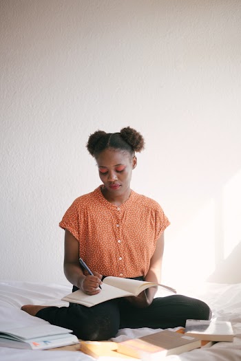 Photo Of Woman Writing On Notebook