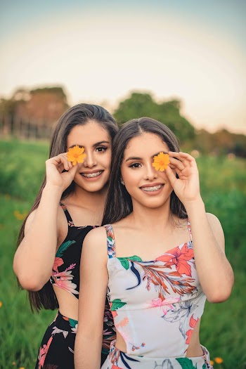 Photo Of Women Holding Flowers