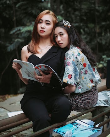 Photo of Women Leaning on each other
