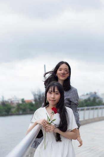 Photo Of Women Leaning On Handrail