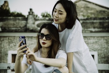 Photo of Women Looking At Mobile Phone