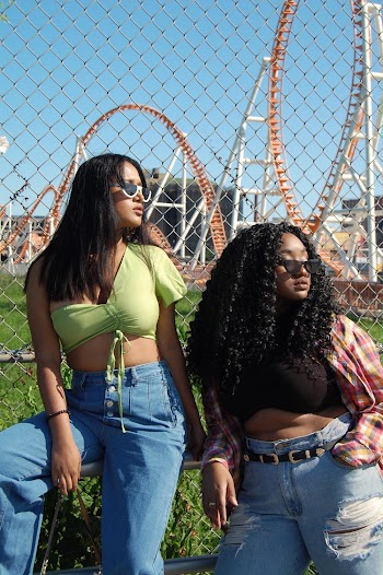 Photo Of Women Near Chain Link Fence