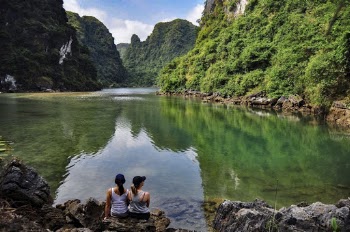 Photo Of Women Sitting Near Lake 