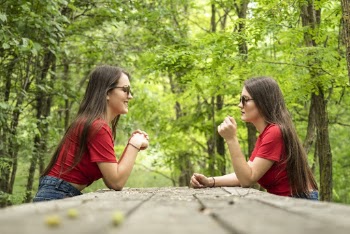 Photo of Women Sitting Near Table Surrounded by Trees