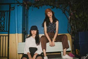Photo of Women Sitting on Bench