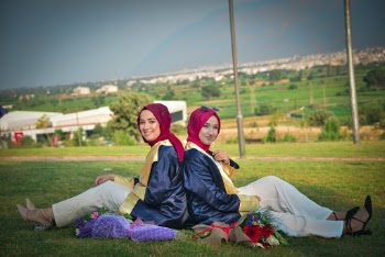 Photo Of Women Sitting On Grass Field
