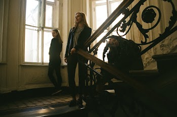 Photo of Women Standing and Sitting Near Stairs