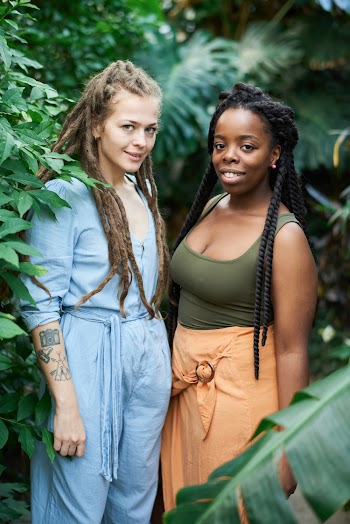 Photo Of Women Standing Near Plants
