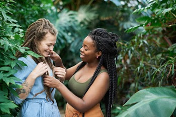 Photo Of Women Standing Near Plants