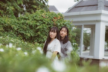 Photo Of Women Standing Near Plants