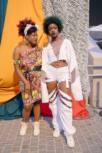 Photo of Women Standing Near Textiles