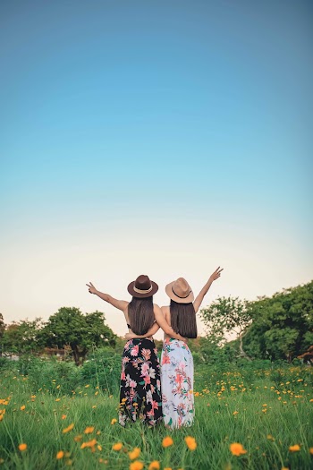 Photo Of Women Standing On Flower Field 