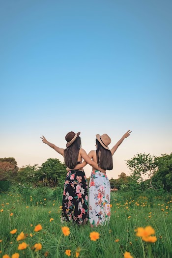 Photo Of Women Standing On Flower Field 