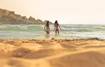 Photo of Women Wearing a Bikini on Beach