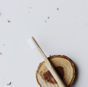 Photo Of Wooden Toothbrush On Top Of Wooden Plank