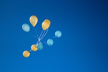 Photo of Yellow And Blue Balloons On Sky
