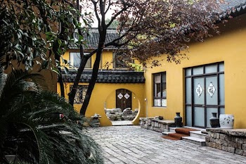 photo of yellow and gray house near trees