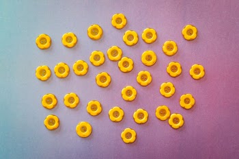 Photo of Yellow Buttons on Surface