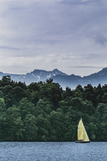 Photo of Yellow Sailboat on Body of Water