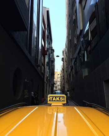 Photo of Yellow Taxi on Narrow Street