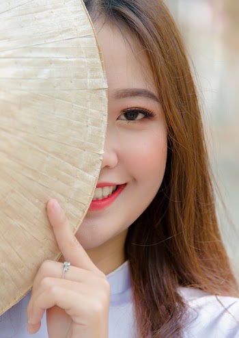 Photo Woman Hiding on Asian Conical Hat