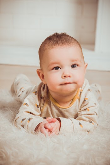 Photograph of a Baby Lying on Tummy