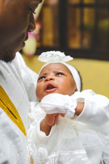 Photograph of a Father Carrying His Baby