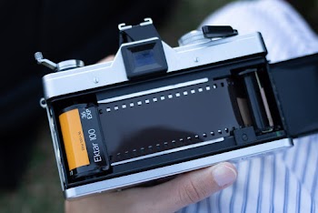 Photograph of a Person Holding a Film Camera