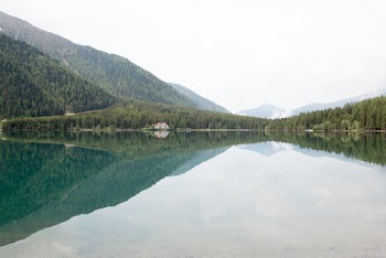 Photograph of Calm Body of Water and Mountain Ranges