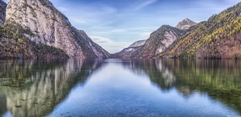 Photograph of Mountain With Plants and Body of Water