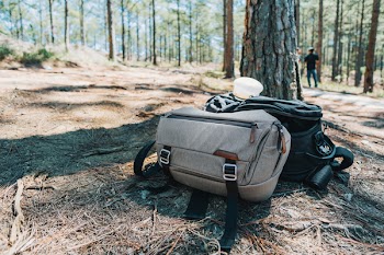 Photograph of Two Duffel Bags Under the Tree in Forest