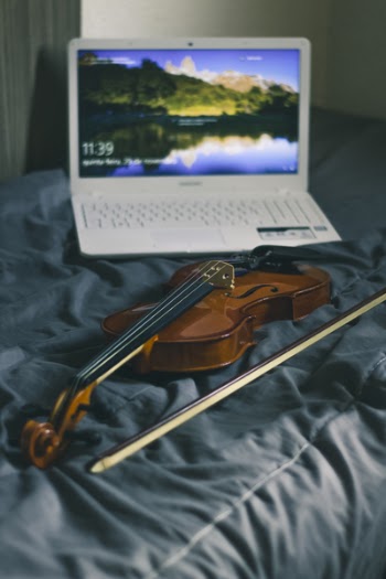 Photograph of White Laptop and Violin
