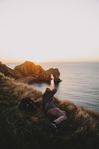 Photographer lying on the grass | Free Photo - rawpixel