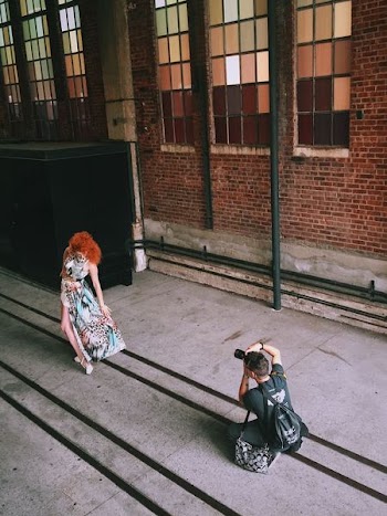 photographer shooting photo of woman in dress posing