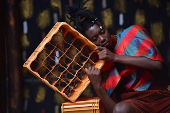 Photography of a Guy Leaning on Plastic Bottle Crate