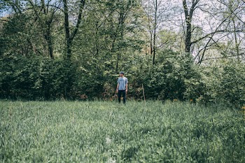 Photography of a Man Standing on Grass Field