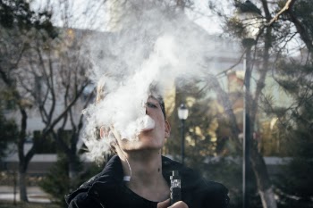 Photography of a Man Using Vape