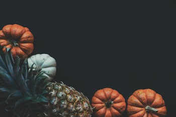 Photography of a Pineapple Fruit Near Two Squashes
